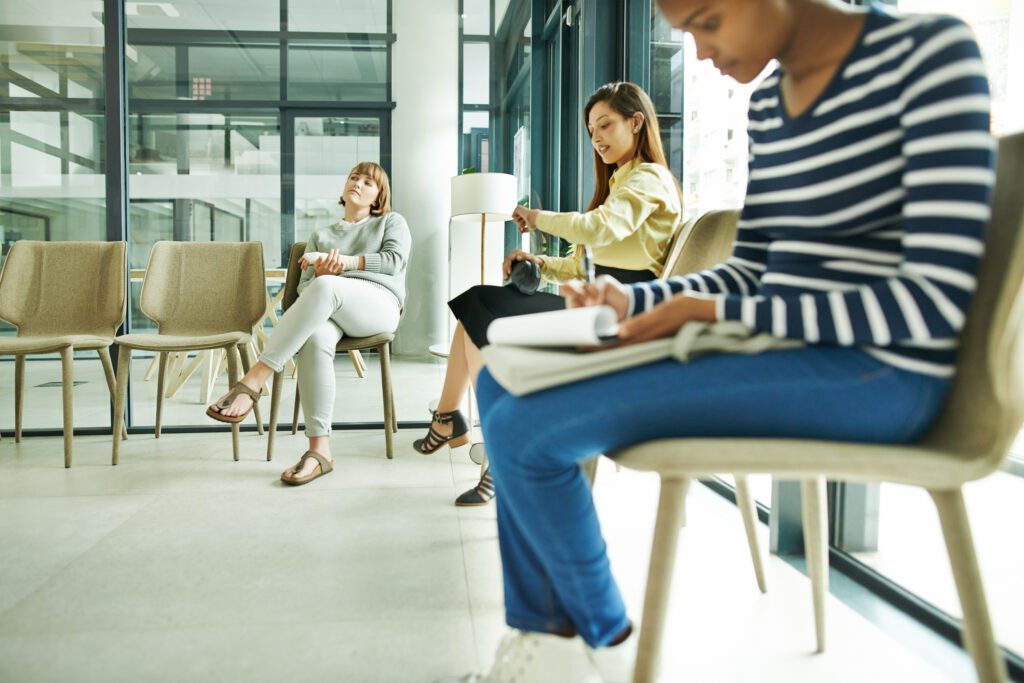 Female patients sit in doctor's waiting room